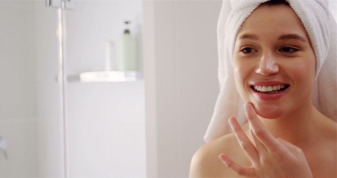 Woman applying moisturizer cream on her face in bathroom at home 4k - Free Images, Stock Photos and Pictures on Pikwizard.com