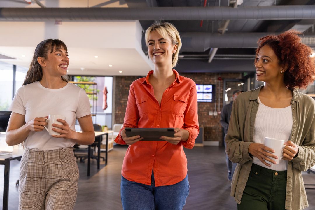 Diverse Coworkers Communicating in Modern Open-Plan Office