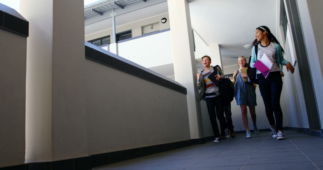 Energetic Students Running in School Corridor