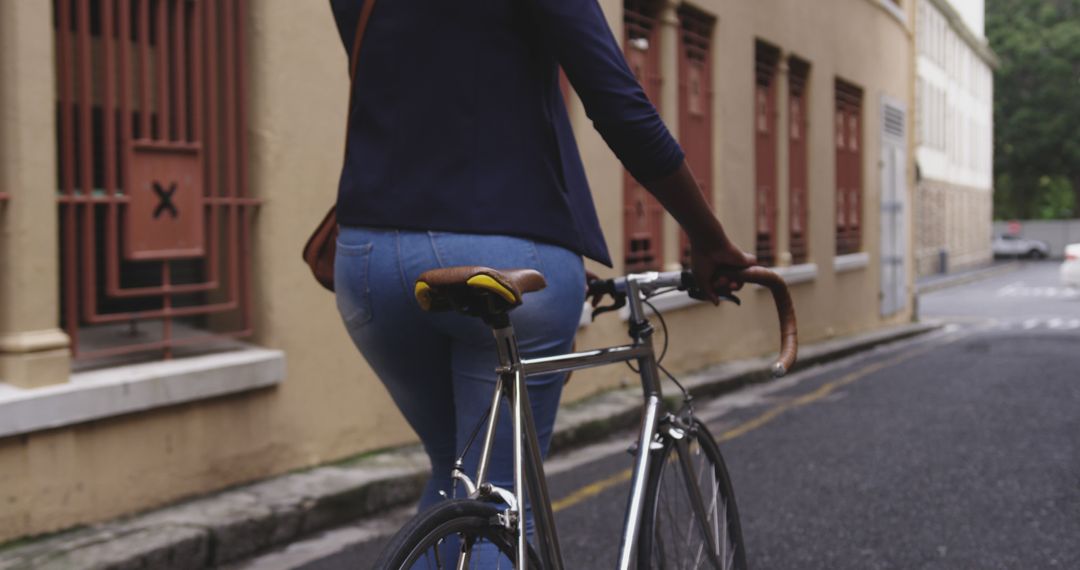 Woman Walking Bicycle on Urban Street Background - Free Images, Stock Photos and Pictures on Pikwizard.com