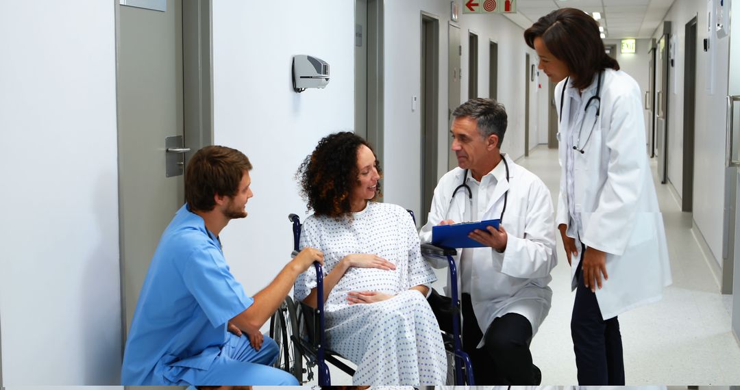 Healthcare Professionals Advising Female Patient in Hospital Hallway - Free Images, Stock Photos and Pictures on Pikwizard.com