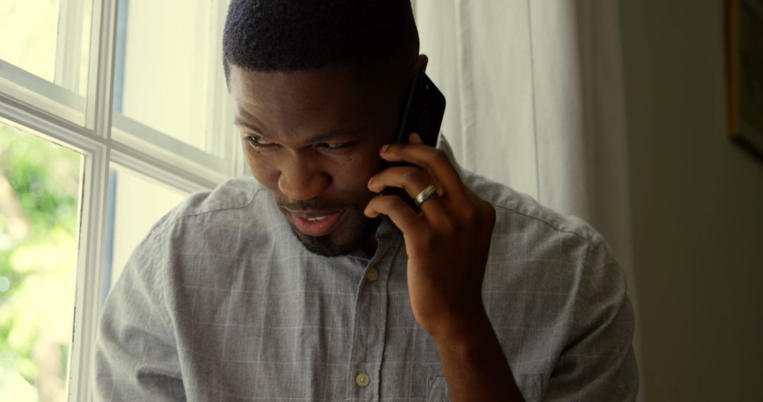 Young Professional Having Phone Conversation at Home