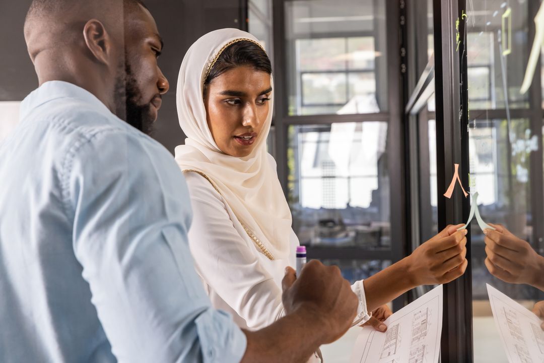 Diverse Team Collaborating on Architecture Project with Sticky Notes