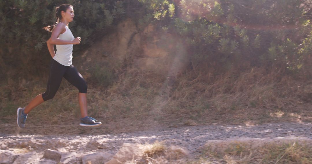 Woman jogging in the countryside on a sunny day - Free Images, Stock Photos and Pictures on Pikwizard.com