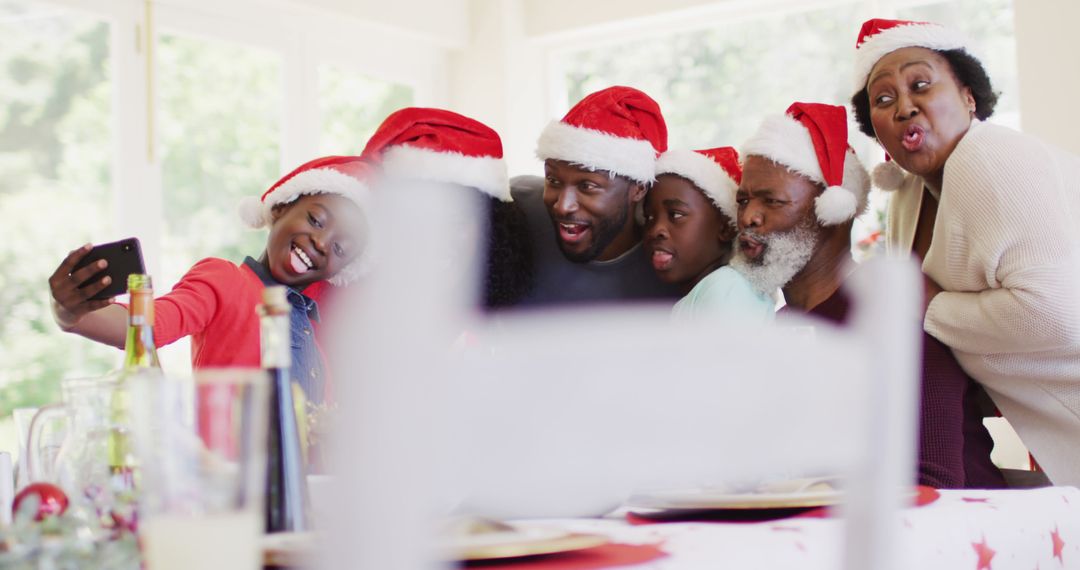 Multigenerational Family Taking Selfie in Santa Hats During Christmas Celebration - Free Images, Stock Photos and Pictures on Pikwizard.com