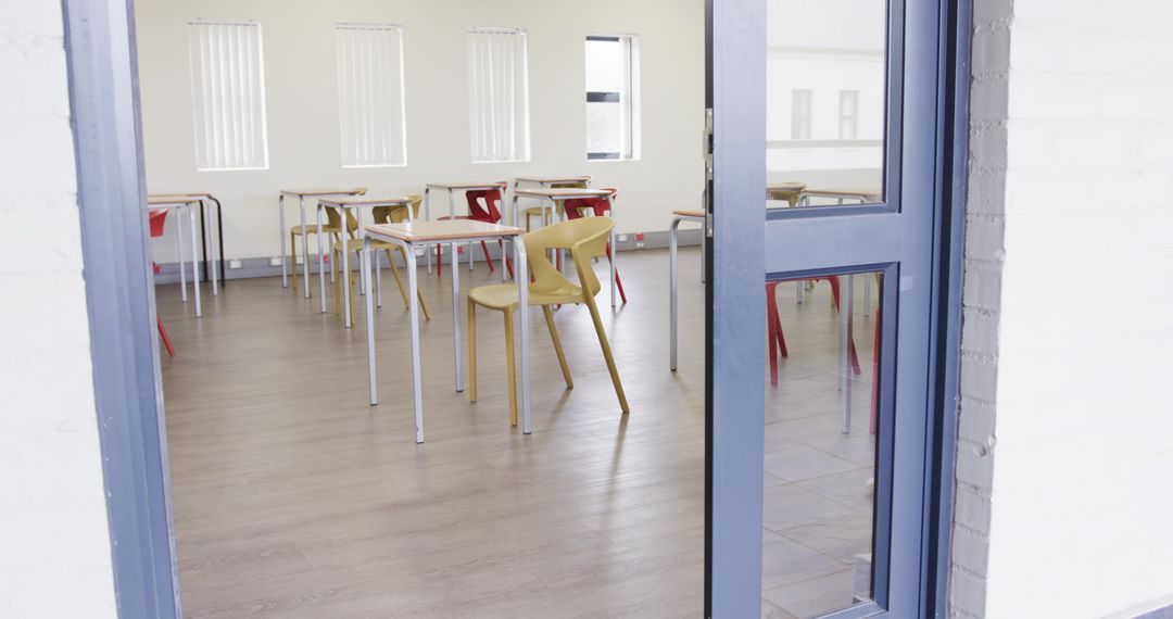 Empty Classroom Interior with Open Blue-Framed Door and Modern Design