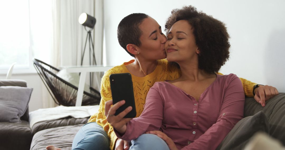 Diverse Couple Embracing While Taking Selfie in Cozy Home Setting