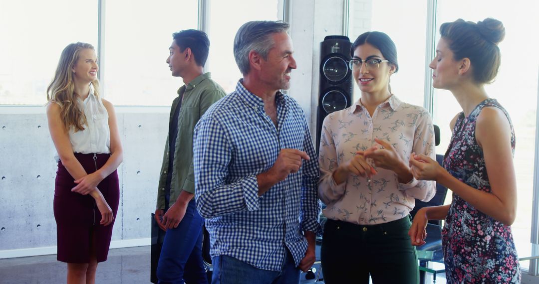 Diverse Professionals Engaging in Office Conversation
