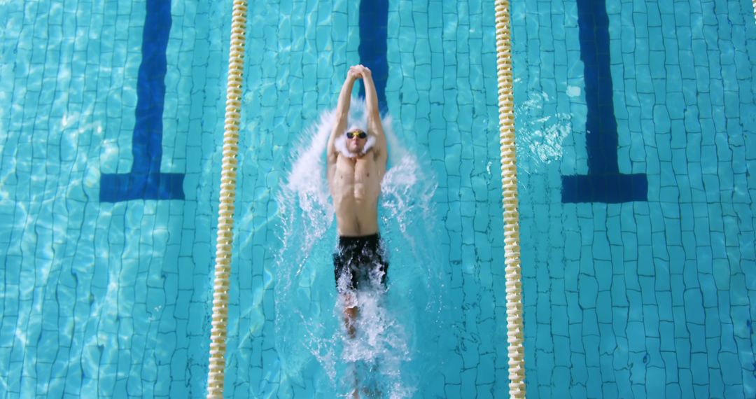 Male Swimmer Competing in Swimming Pool from Above - Free Images, Stock Photos and Pictures on Pikwizard.com