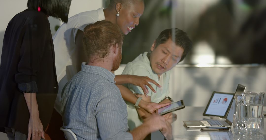 Diverse Team Analyzing Data During Late-Night Office Collaboration