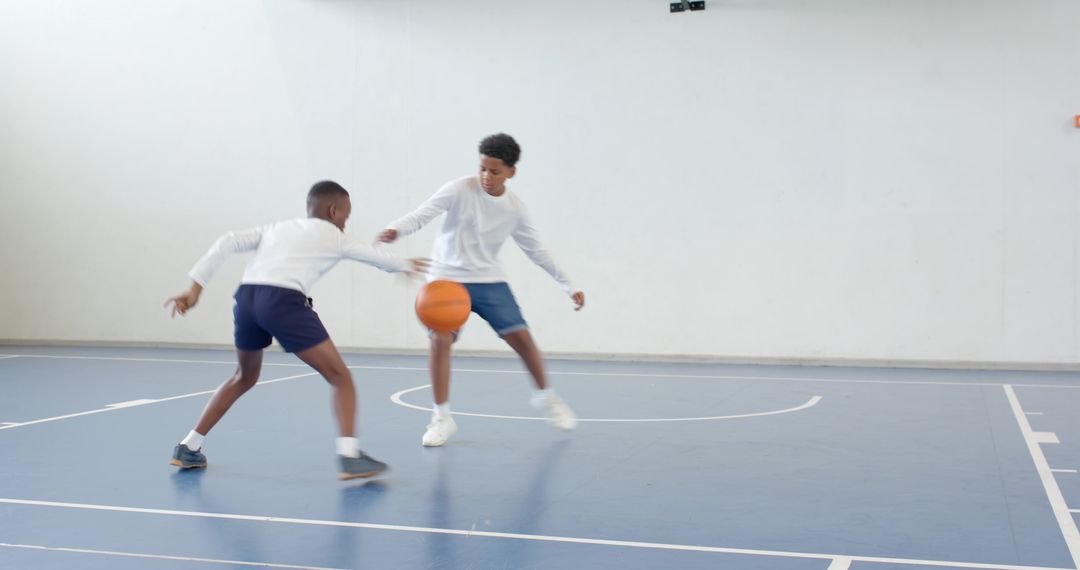 Boys Playing Basketball in Indoor Gym Pursuing Agile Dodges