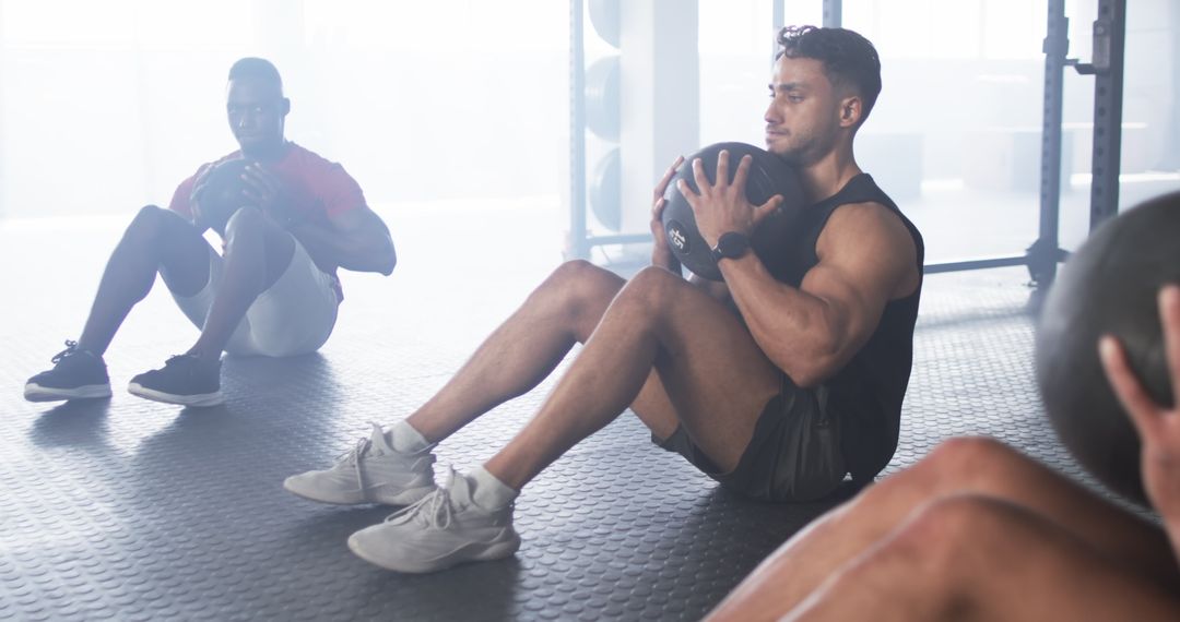 Men Exercising with Medicine Balls in Gym for Core Strength