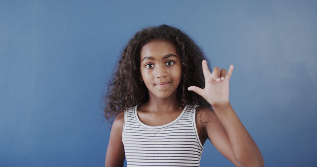 Young Girl Using American Sign Language 'I Love You' Gesture - Free Images, Stock Photos and Pictures on Pikwizard.com