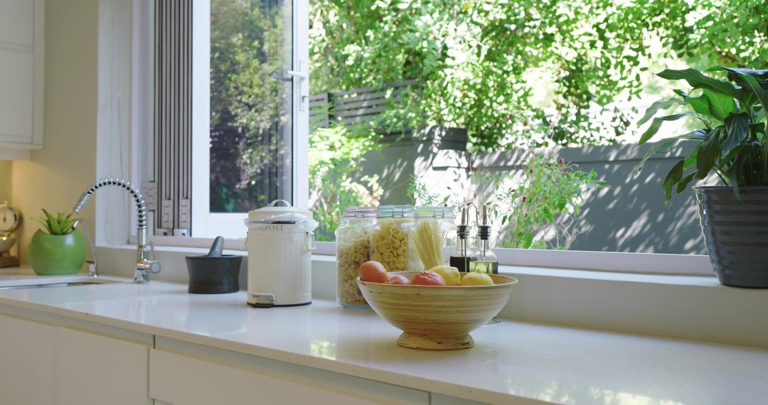 Sunlit Kitchen Counter with Jar and Fresh Fruit Bowl