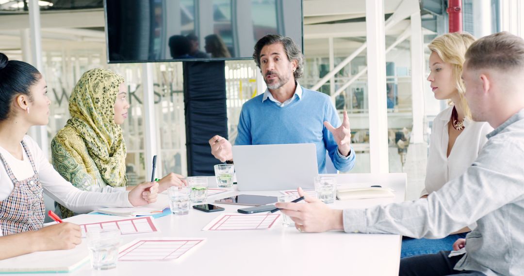 Diverse Team Discussion in Bright Office Demonstrating Effective Collaboration
