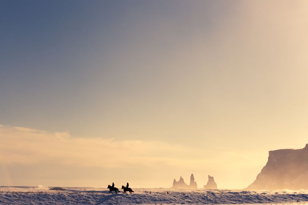 Horseback Riders at Dawn on Snowy Landscape with Rock Formations in Distance - Free Images, Stock Photos and Pictures on Pikwizard.com