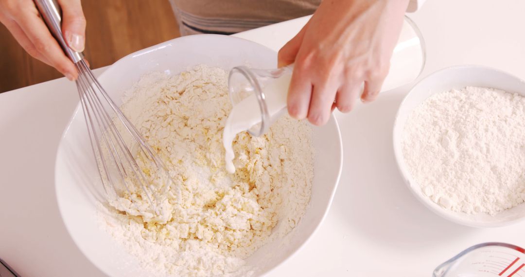 Person Mixing Flour and Milk for Baking in Kitchen - Free Images, Stock Photos and Pictures on Pikwizard.com