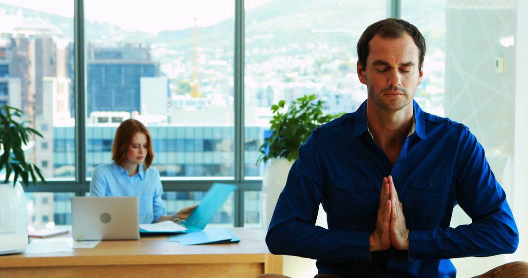 Businessman Practicing Meditation and Calmness in Modern Office - Free Images, Stock Photos and Pictures on Pikwizard.com