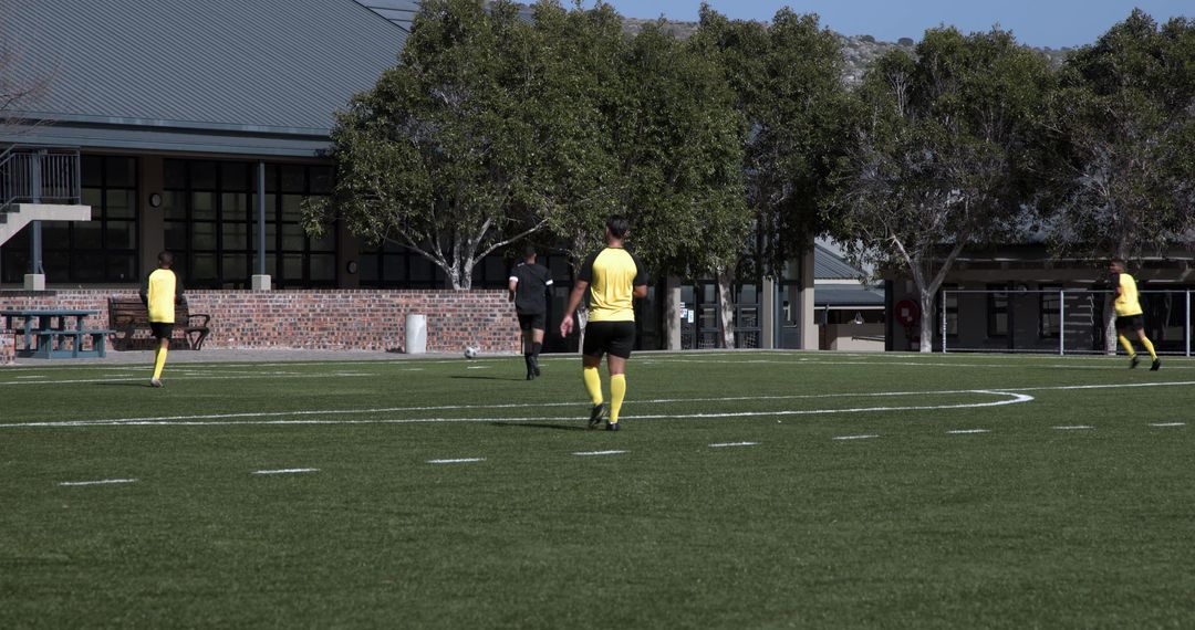 Teen Soccer Players Practicing Teamwork and Passing Skills on Field