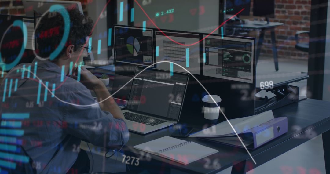 Businessman Analyzing Financial Data on Multiple Screens