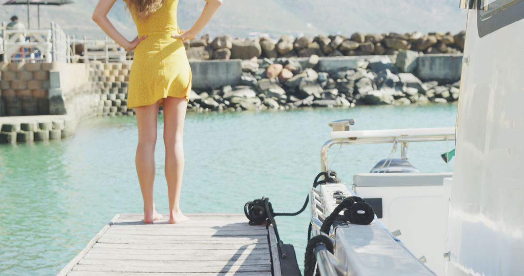 Woman in Yellow Dress Standing on Dock Near Boat - Free Images, Stock Photos and Pictures on Pikwizard.com