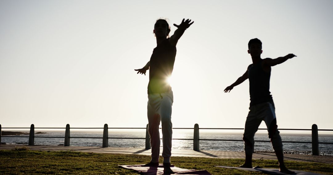 Couple Practicing Yoga Outdoors during Sunset by the Sea - Free Images, Stock Photos and Pictures on Pikwizard.com