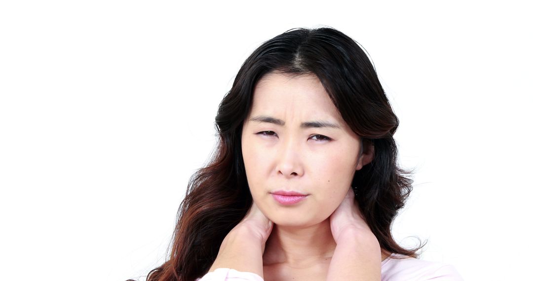 Asian Woman Experiencing Neck Pain Isolated on White Background - Free Images, Stock Photos and Pictures on Pikwizard.com