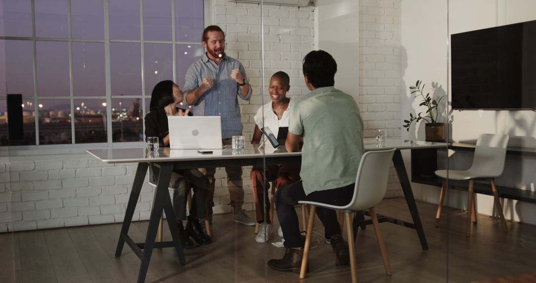 Diverse Business Team Collaborating in Modern Office Evening