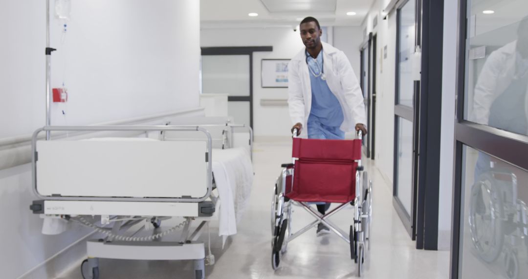 Healthcare Professional Pushing Empty Wheelchair in Hospital Corridor - Free Images, Stock Photos and Pictures on Pikwizard.com