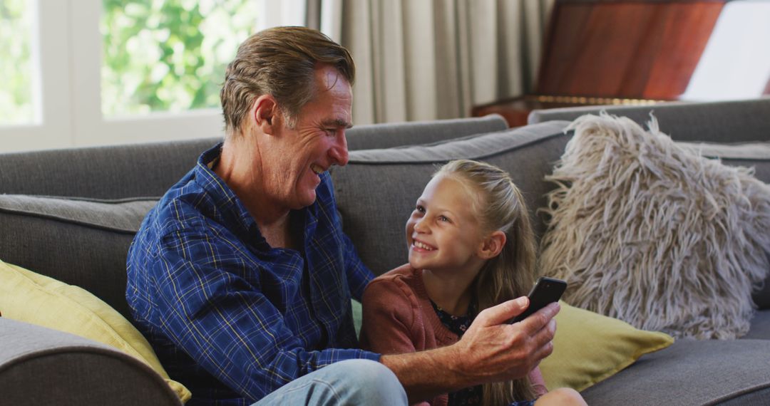 Cheerful Grandpa And Granddaughter Spending Quality Time With Remote Control - Free Images, Stock Photos and Pictures on Pikwizard.com