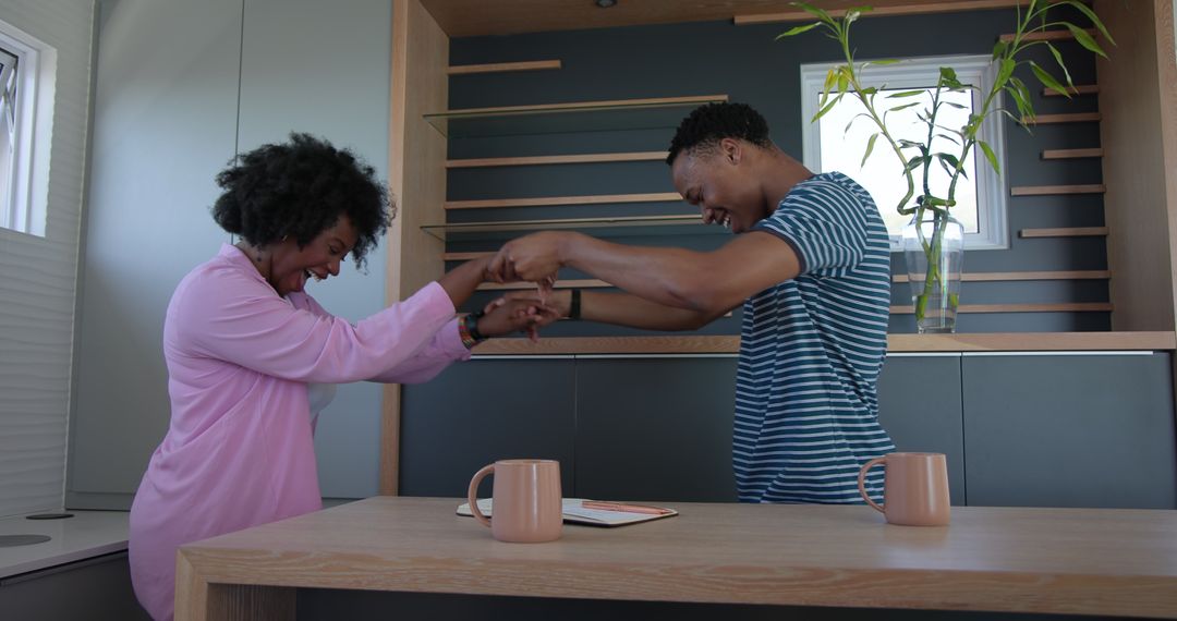 Happy Couple Sharing Joyful Moment in Modern Kitchen