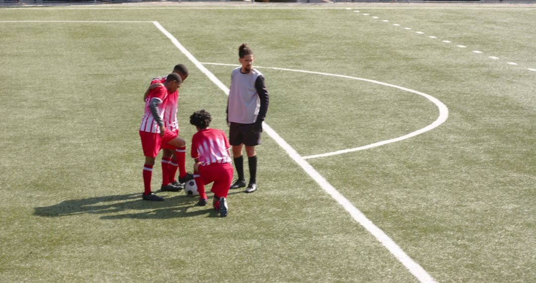 Soccer Team Strategizing on Field During Competitive Match