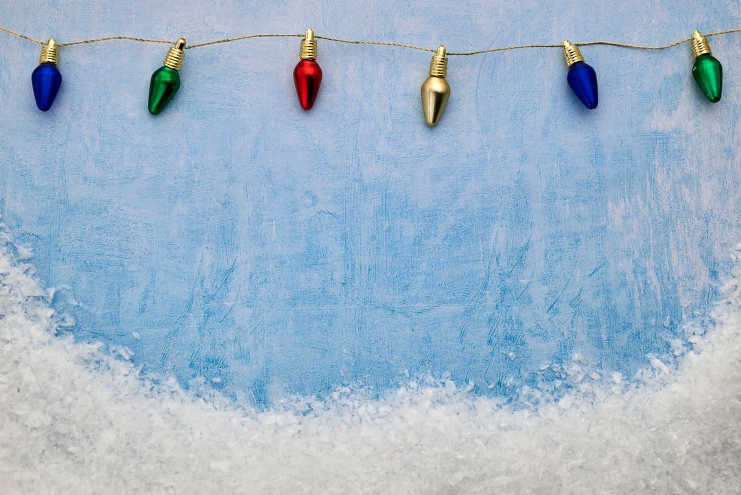 Festive String Lights Over Snowy Background for the Holidays