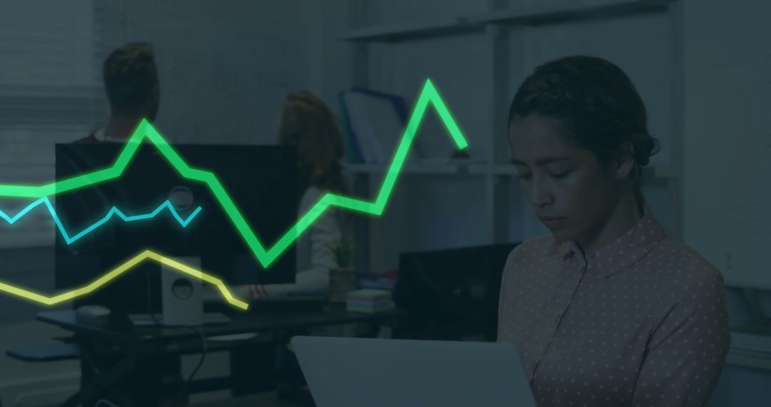 Businesswoman Analyzing Data on Laptop with Digital Graphs in Office