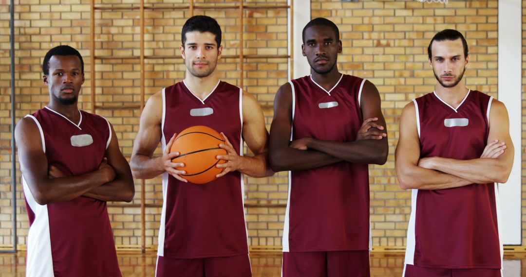 Portrait of confident basketball players holding basketball in court - Free Images, Stock Photos and Pictures on Pikwizard.com