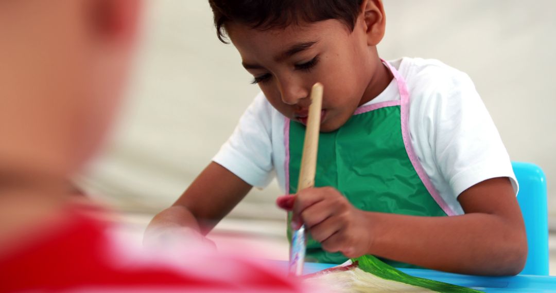 Young Boy Concentrating While Painting at Art Class - Free Images, Stock Photos and Pictures on Pikwizard.com