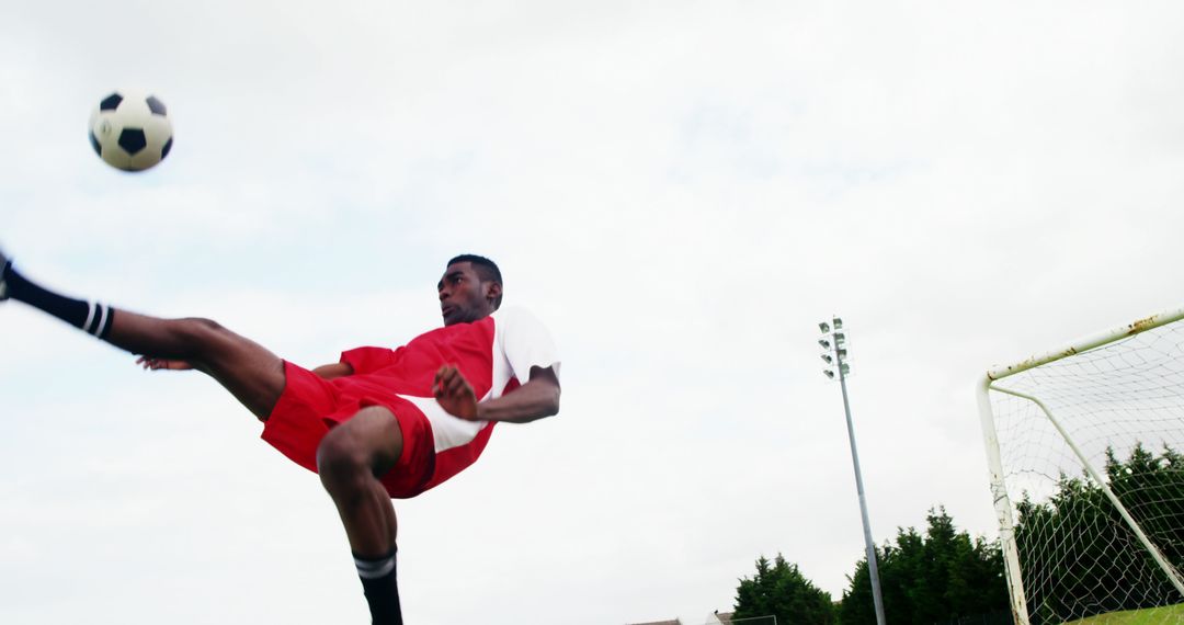 An athletic African American soccer player executes a skillful high kick in a game. - Free Images, Stock Photos and Pictures on Pikwizard.com