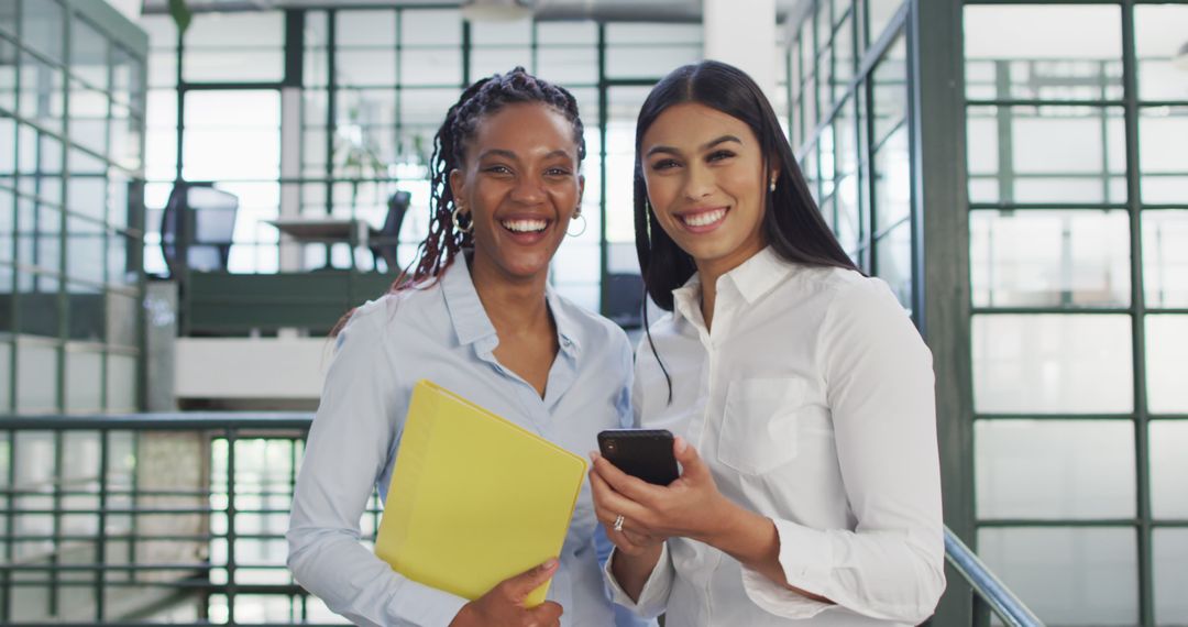 Diverse Businesswomen Smiling Together in Modern Office - Free Images, Stock Photos and Pictures on Pikwizard.com