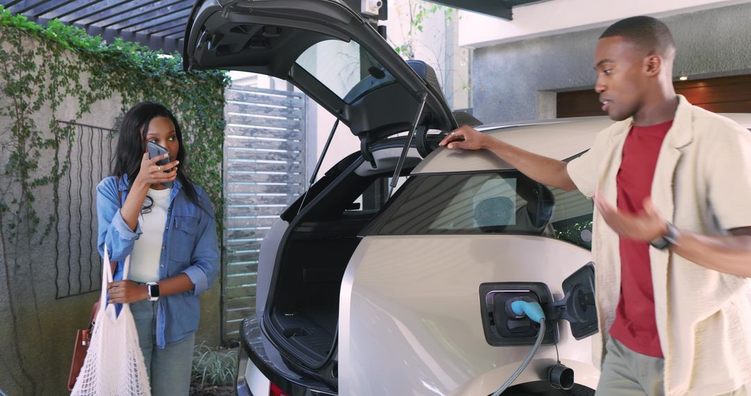 Couple Troubleshooting Electric SUV Charging in Driveway