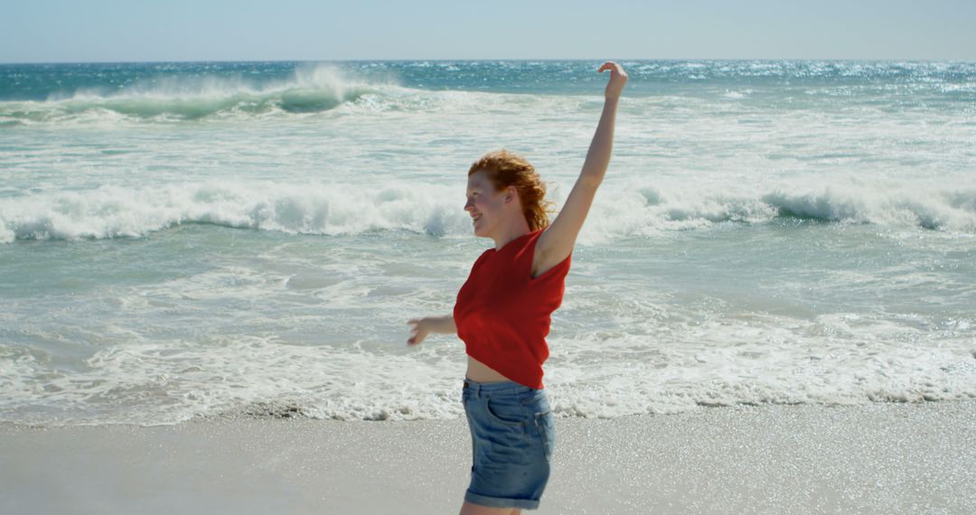 Joyful Woman Dancing on Beach in Daytime - Free Images, Stock Photos and Pictures on Pikwizard.com