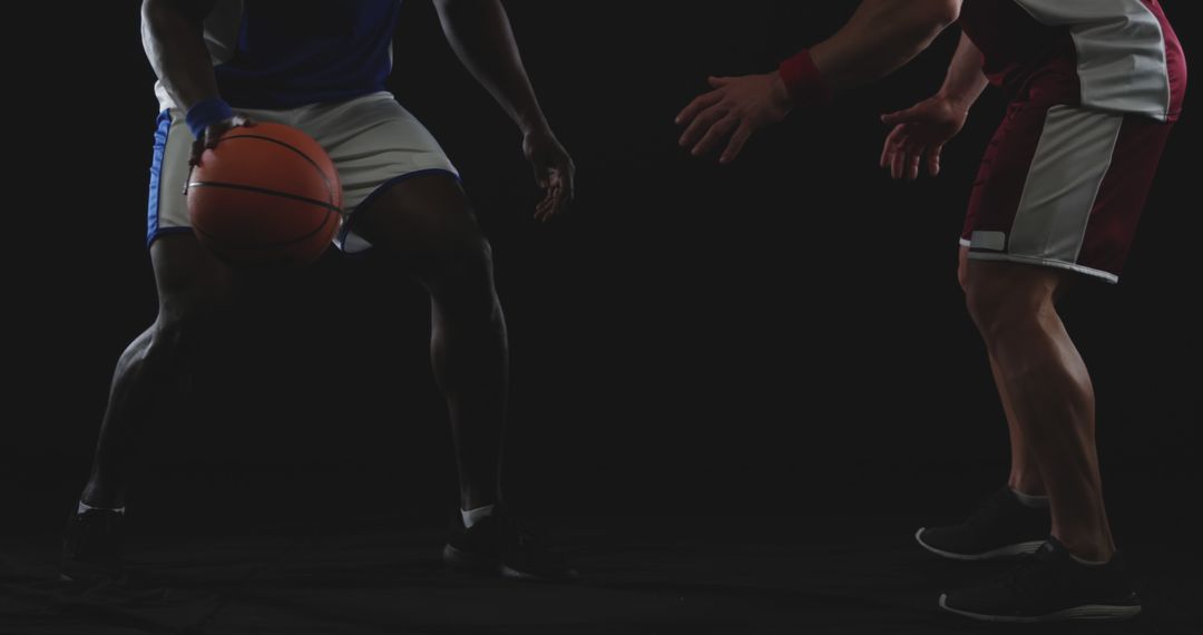 Two Basketball Players Competing in Match on Dark Background - Free Images, Stock Photos and Pictures on Pikwizard.com