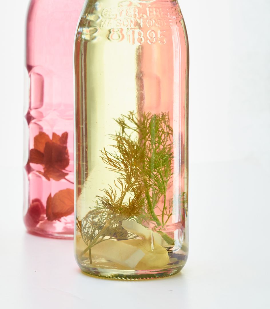 Glass Bottles Infused with Herb and Flower Arrangement