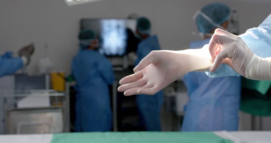 Surgeon Putting on Gloves in Operating Room - Free Images, Stock Photos and Pictures on Pikwizard.com