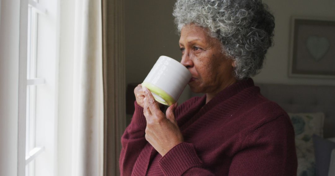 Senior Woman Drinking Coffee by Window at Home - Free Images, Stock Photos and Pictures on Pikwizard.com