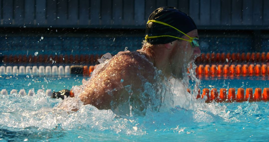 Competitive Swimmer Mid-Action in Swimming Pool - Free Images, Stock Photos and Pictures on Pikwizard.com