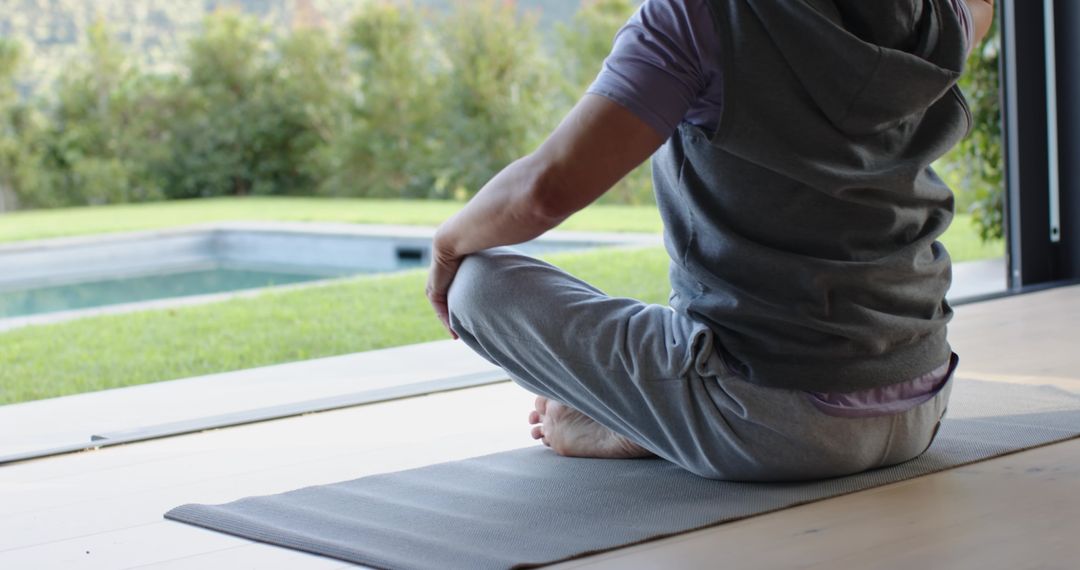 Senior Man Meditation by Poolside in Tranquil Setting