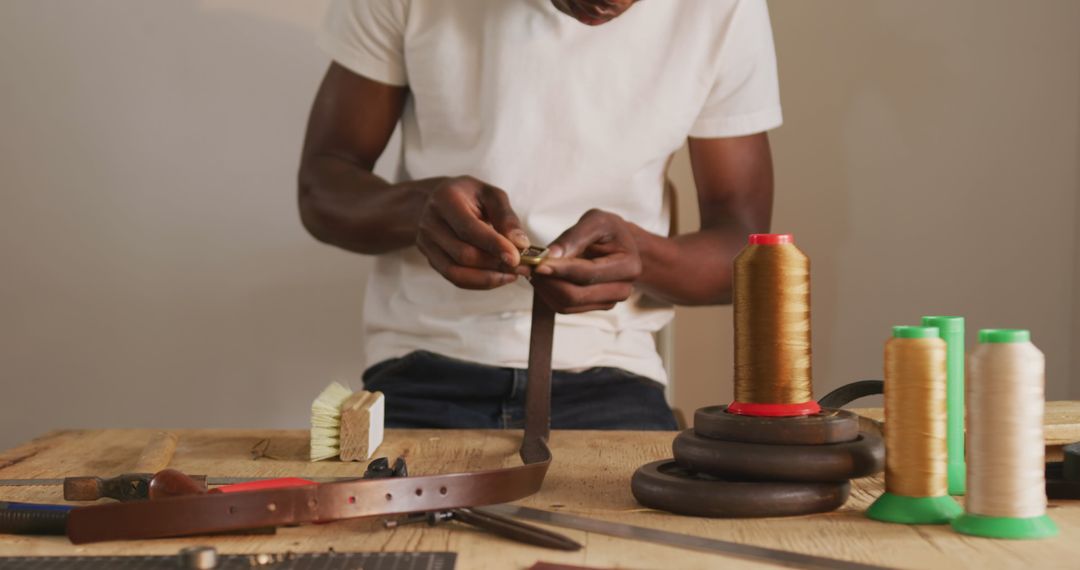 Artisan Crafting Leather Belt in Workshop with Tools