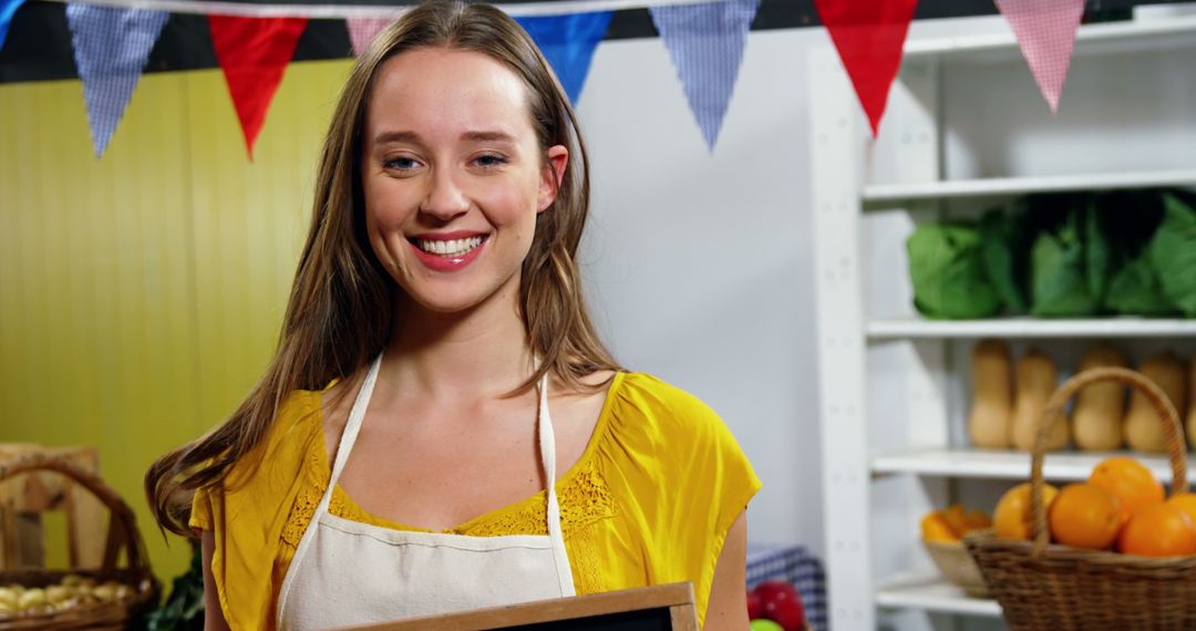 Young Woman Smiling at Farm Market Displaying Chalkboard Sign - Free Images, Stock Photos and Pictures on Pikwizard.com