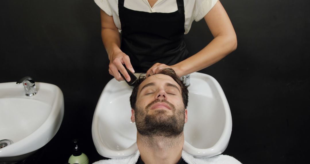 Man Relaxing During Hair Wash at Salon in Spa - Free Images, Stock Photos and Pictures on Pikwizard.com