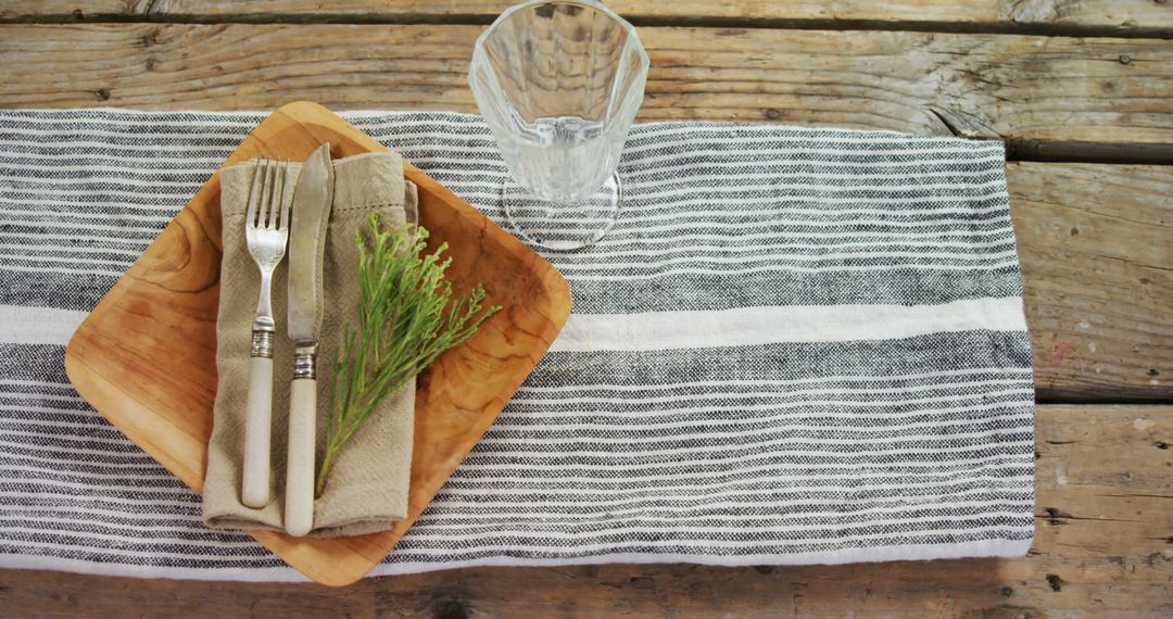 Rustic Table Setting with Wooden Plate, Cutlery and Glass - Free Images, Stock Photos and Pictures on Pikwizard.com